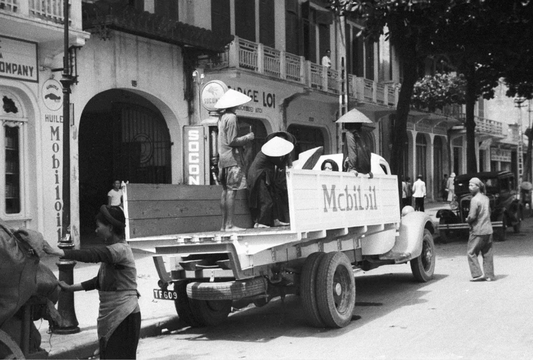 people loading large boxes from the back of a truck