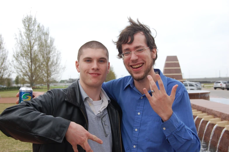 a couple of men are posing with each other