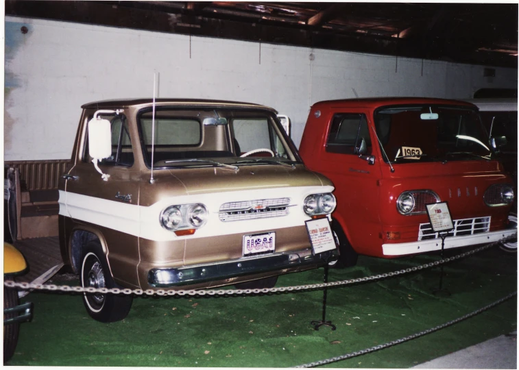 two cars are parked in a storage area with rope