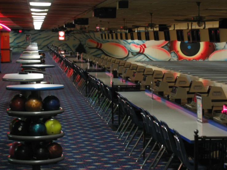 bowling alley with bowling pins and bowling balls on the table