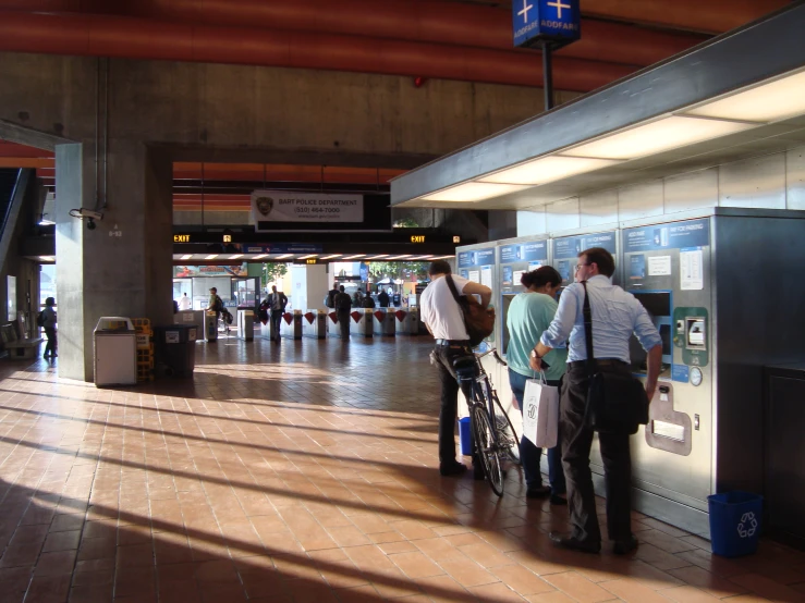 a group of people are standing with their luggage