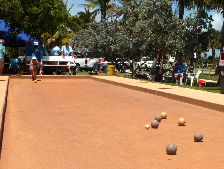 two people playing a game of outdoor bowling