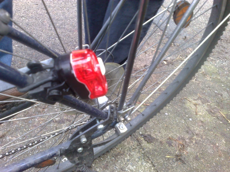 a rear light on a bicycle outside,