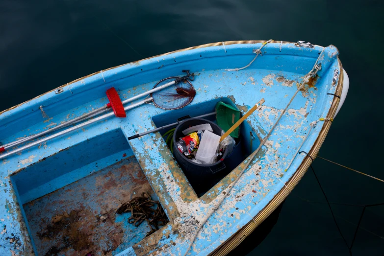 an empty blue boat floating in the water