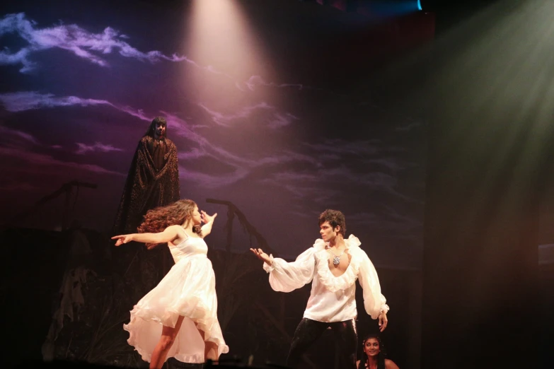 people on stage performing a trick with a magician