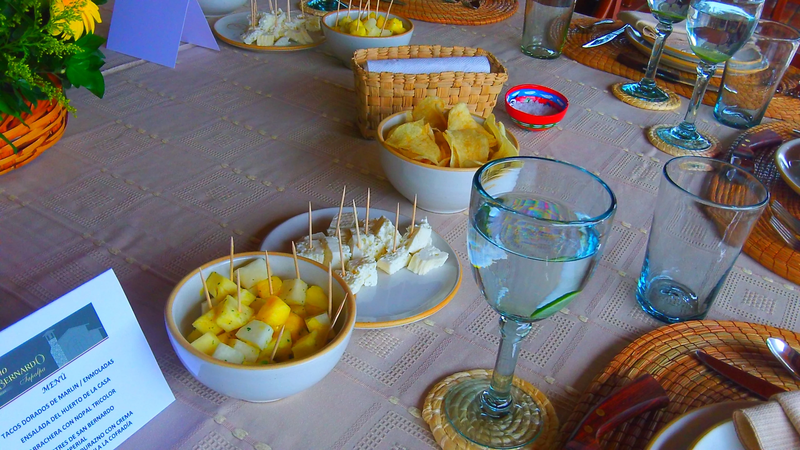 a table has white bowls with food inside of them