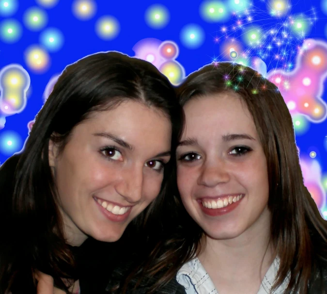 two girls are taking a selfie in front of a fireworks display