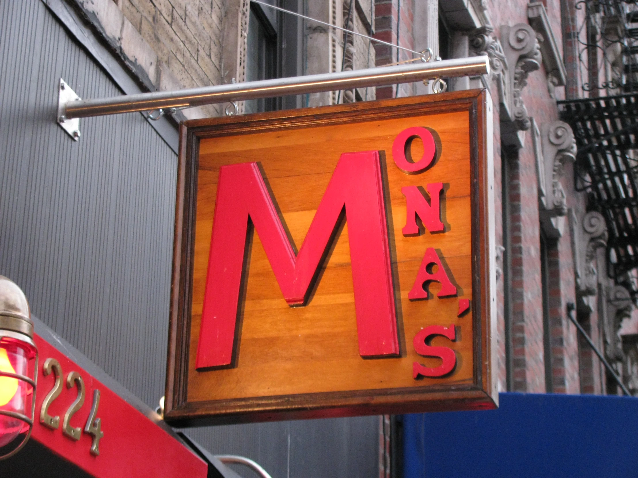 a sign hanging outside of a restaurant called ms - class