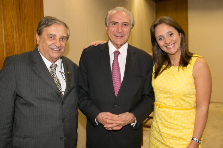 two men and a woman are standing together