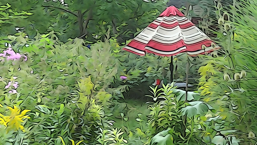 an umbrella is sitting in the middle of the flowers