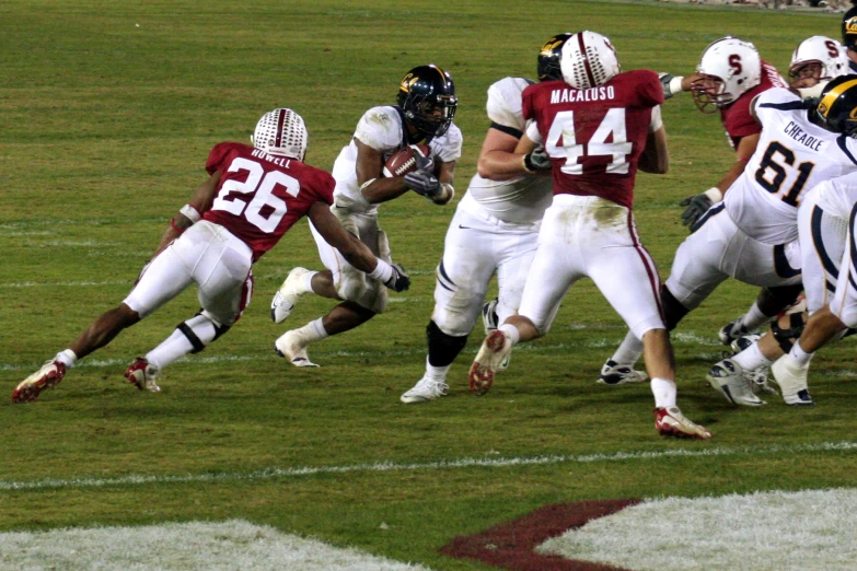 a football game with the opposing team being chased by the opponent