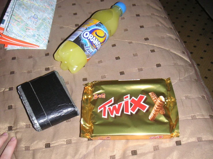 an assortment of food with a bag and a cell phone