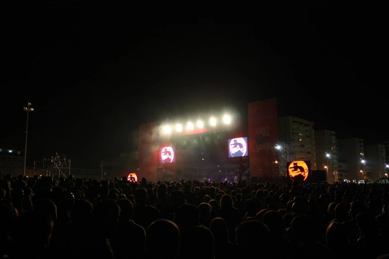 a big crowd watching two concert lights show
