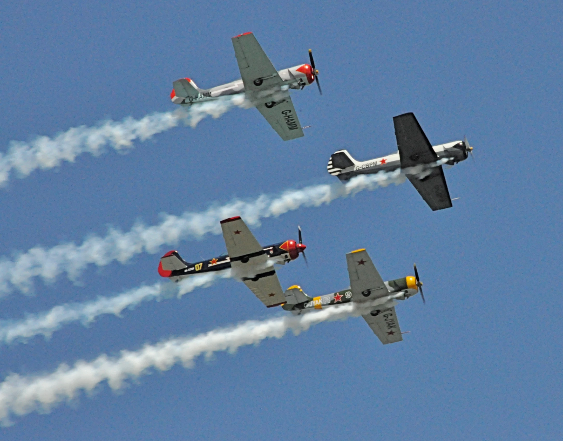 a squadron of four planes flying in formation