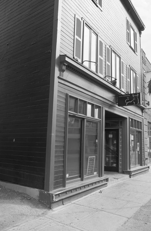 black and white pograph of a building, window shopping center and street