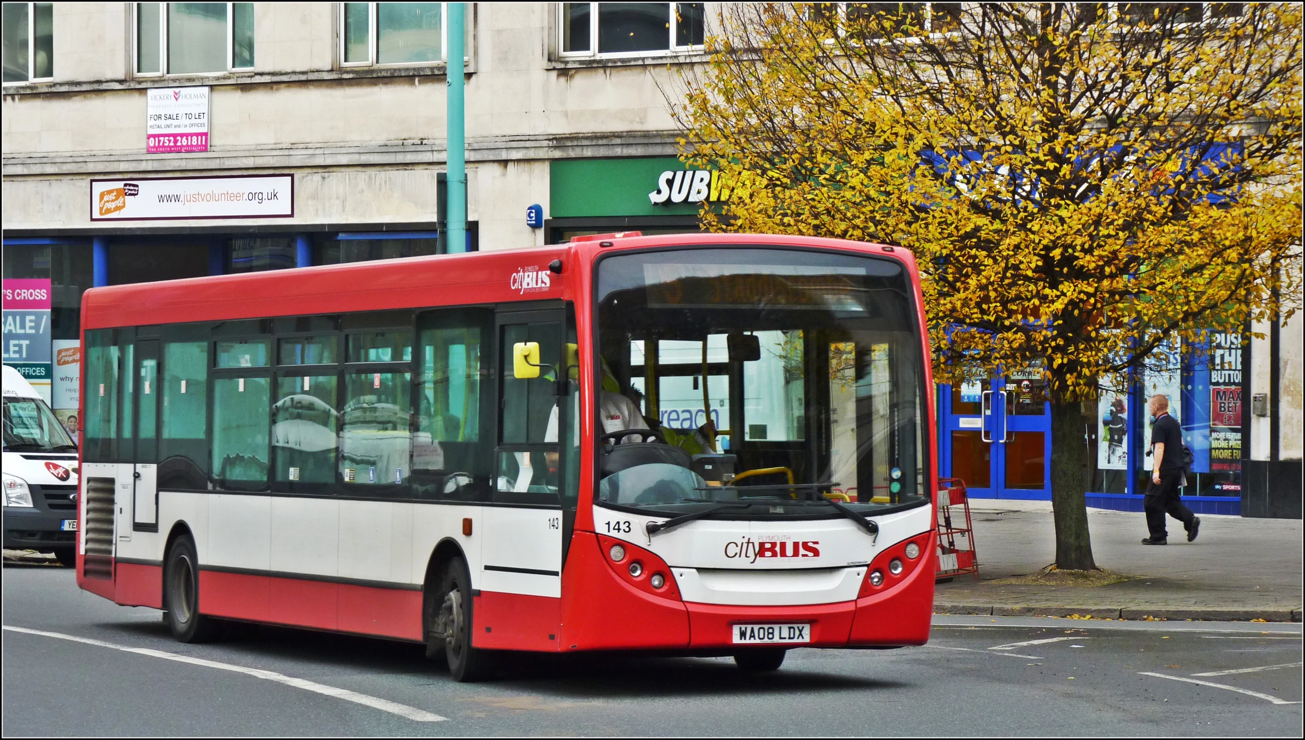 a bus driving on the street of a city