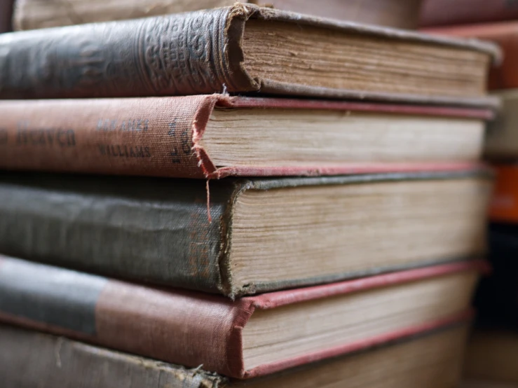 a bunch of books stacked together on top of each other