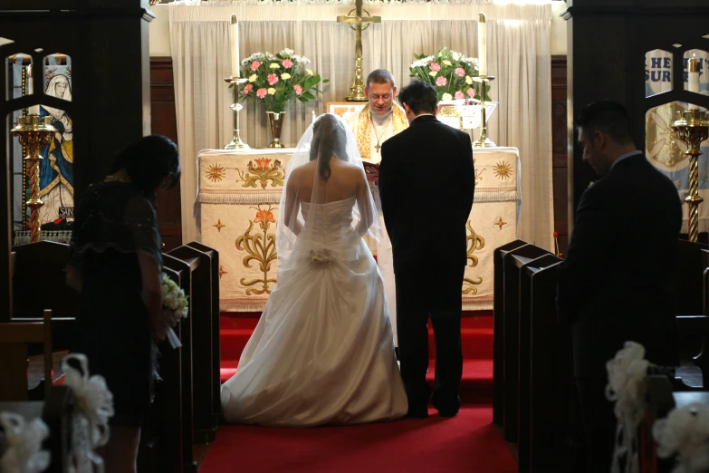 a bride and groom standing in front of the altar at a wedding ceremony