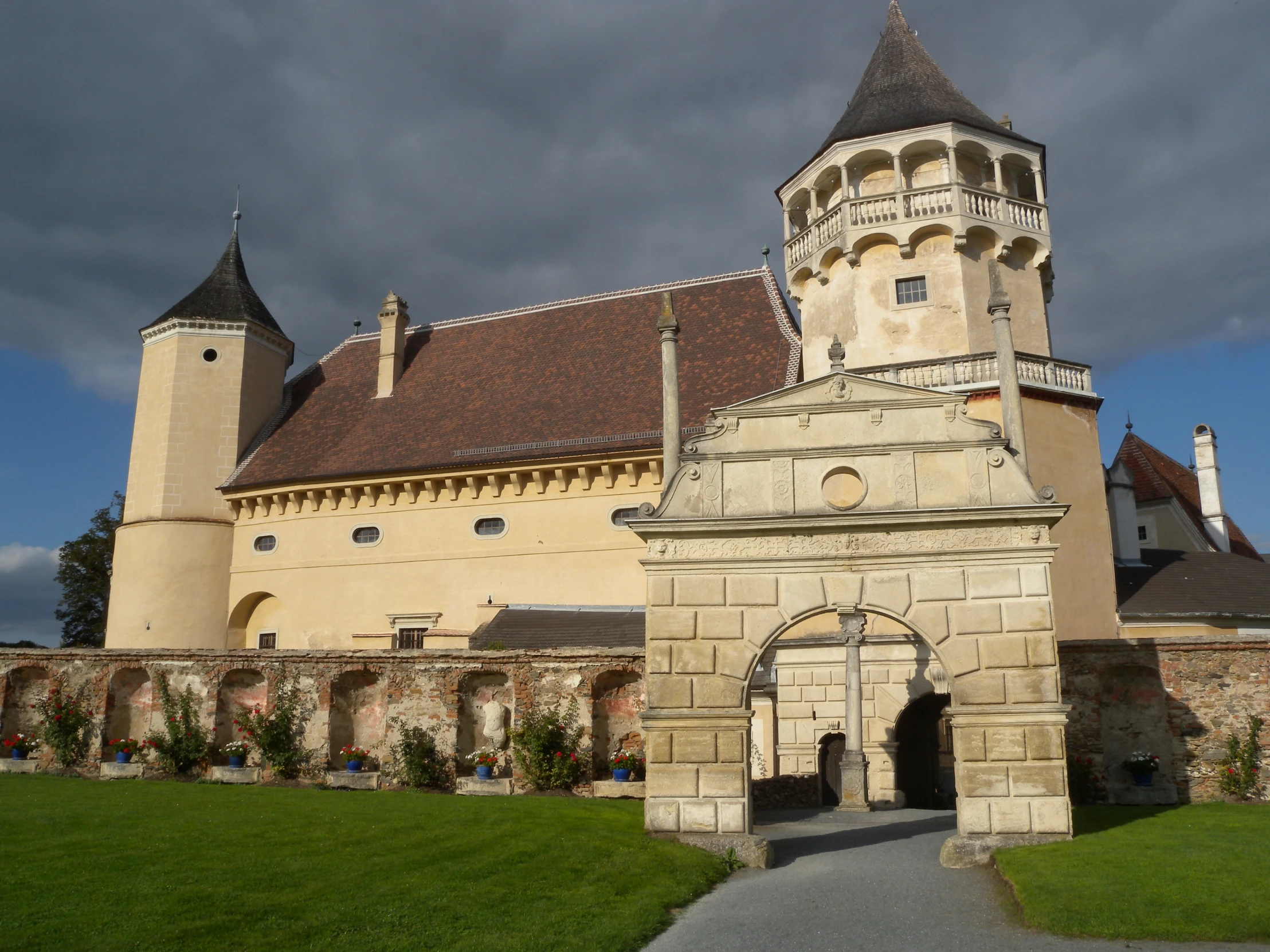 a brick castle with towers and an archway