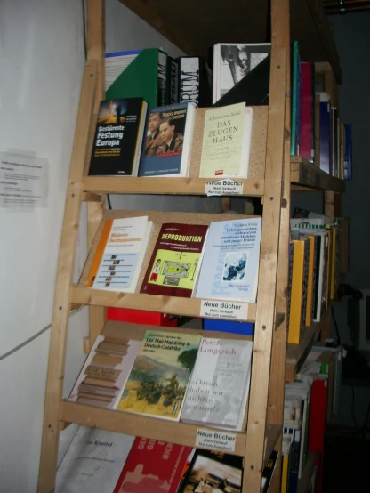 a tall wooden shelf filled with lots of books