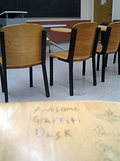 five chairs and a table with an advertit on the table