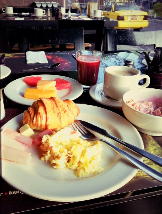 a white plate filled with food next to a cup of tea