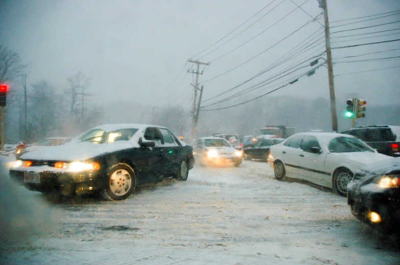 cars driving in heavy snow with power lines above