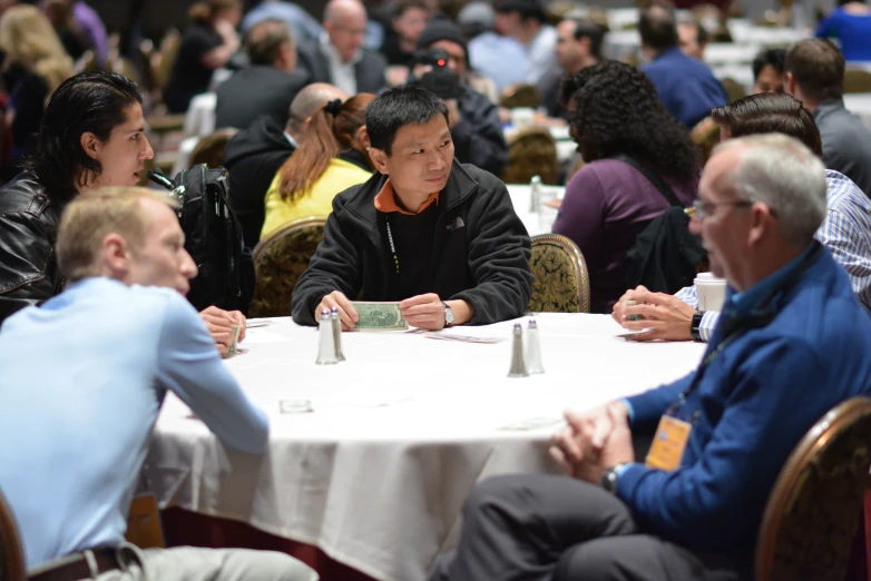 people sitting at a table in the middle of the room