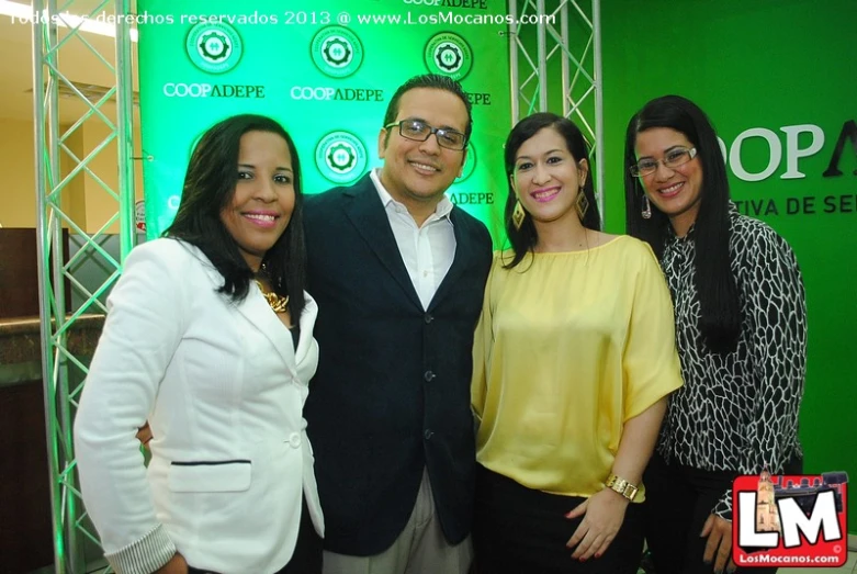 three women, one man and a man in white at an event