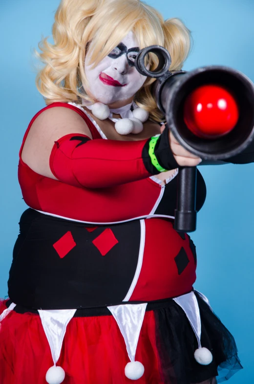 a woman in a costume holding a gun