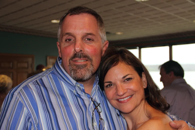 a man and woman smiling for the camera