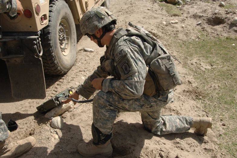 a soldier prepares to attach a device to another