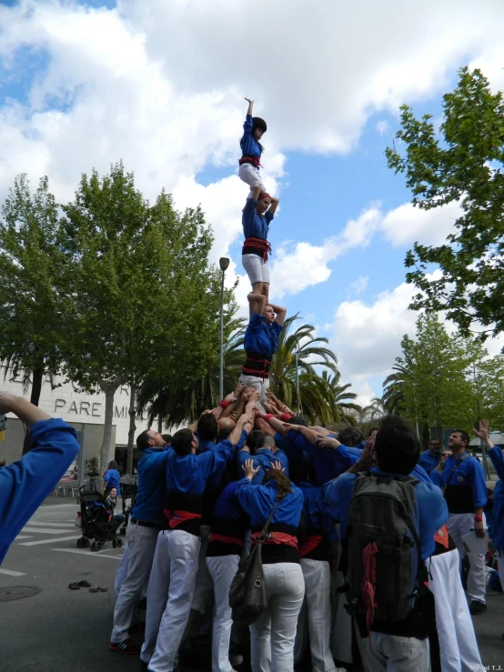 group of people standing around and doing a handstand
