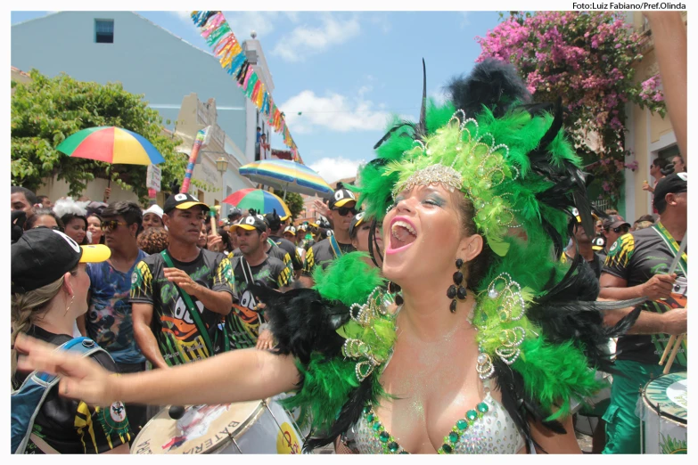 a woman in green and gold clothes is dancing around