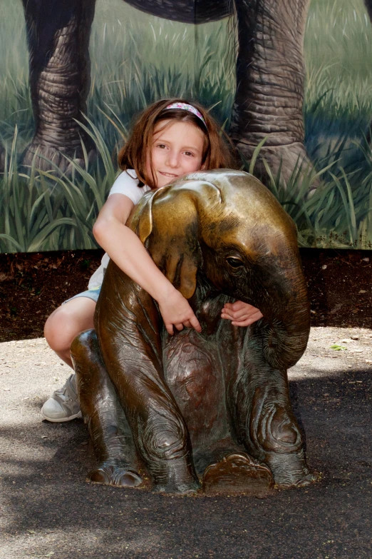 a  holding onto an elephant statue