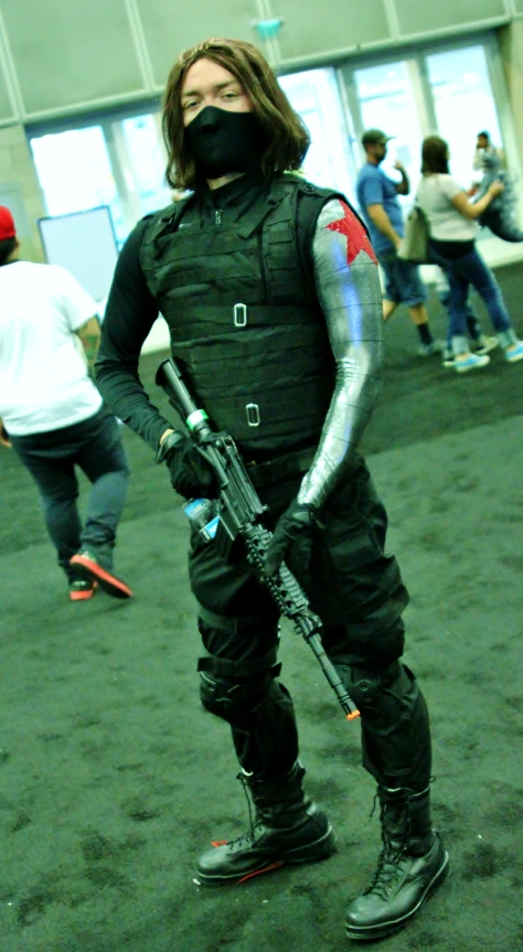 a man in full gear and weapons is posing