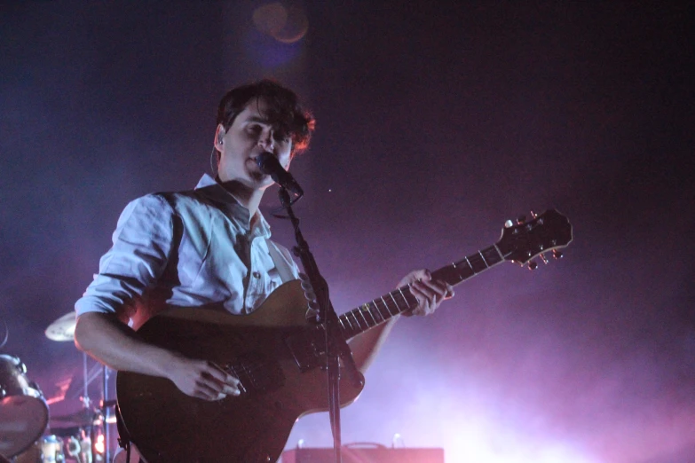 a man with a guitar at a concert