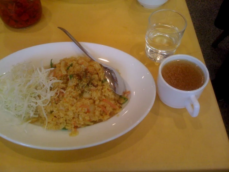 a bowl with rice and other food sitting on top of a table