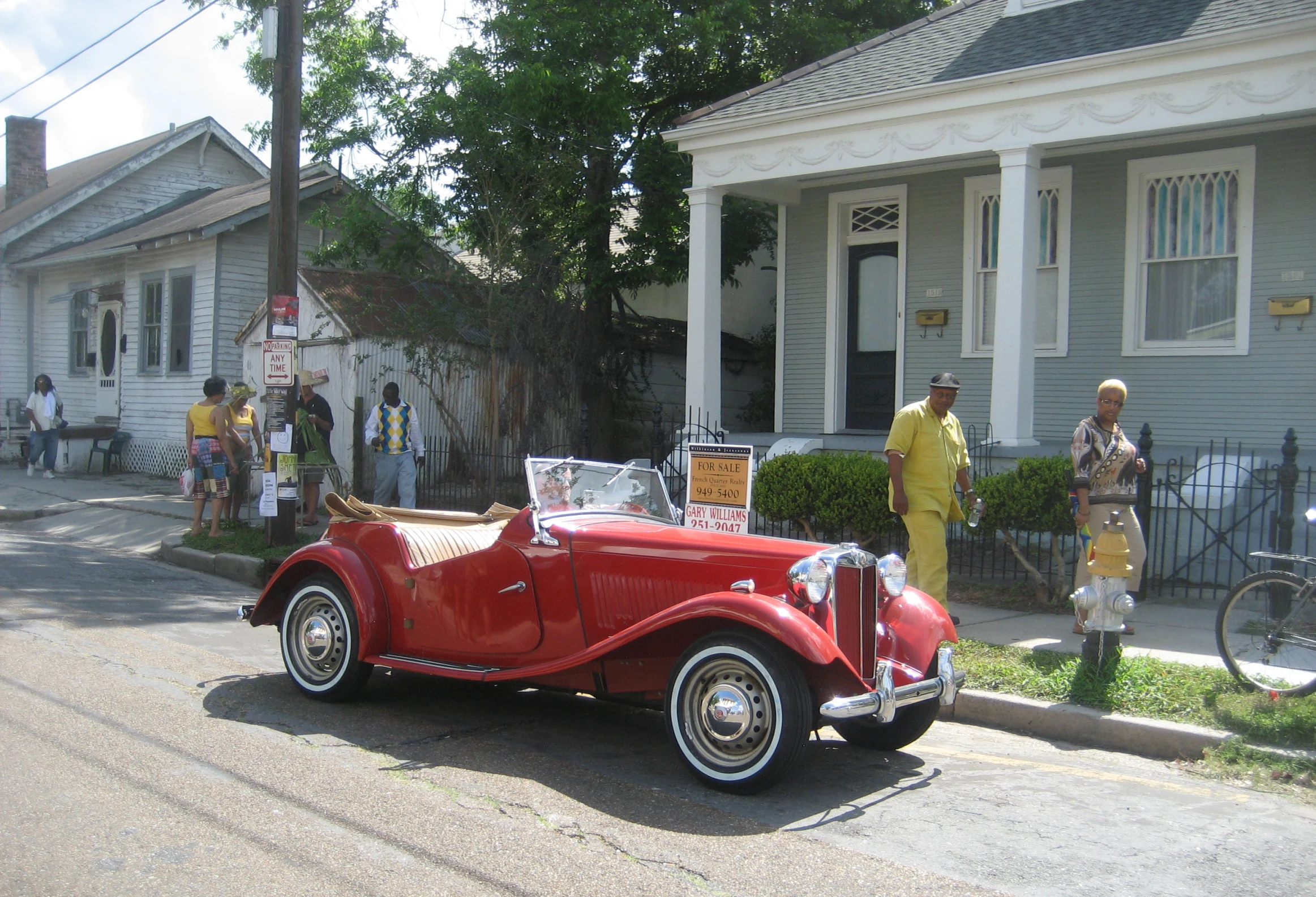 the old fashioned car is parked in the street