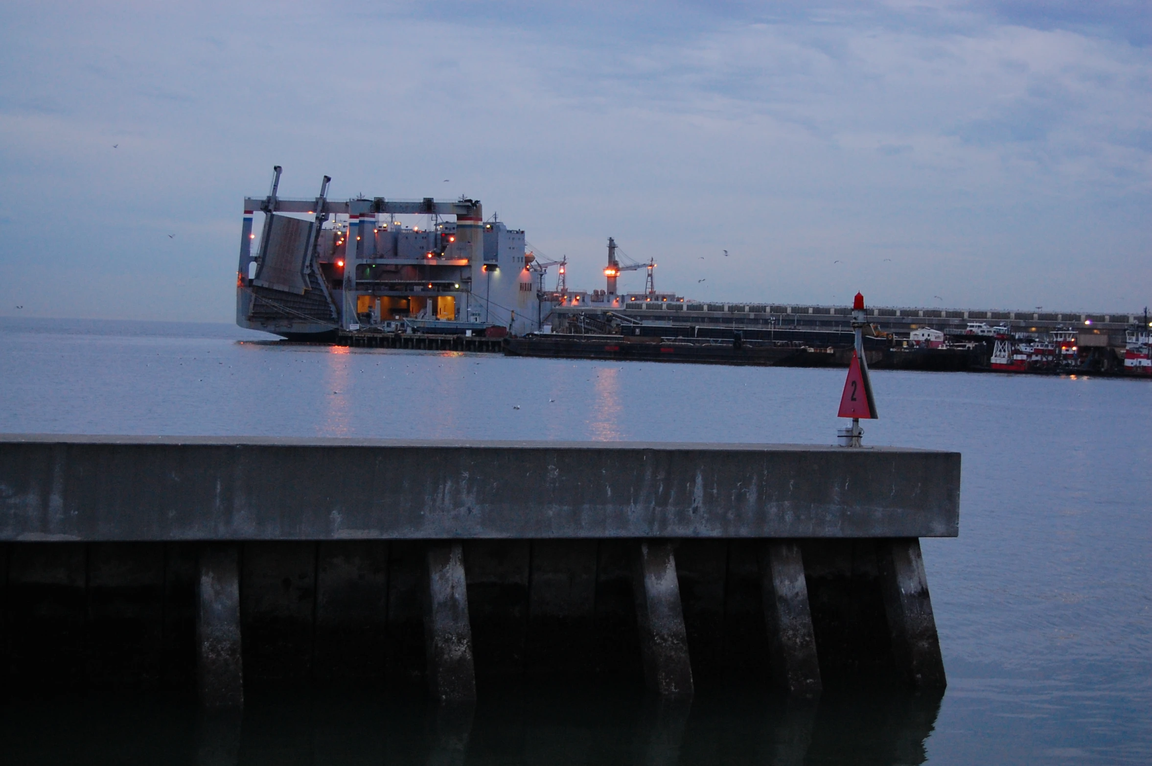 a harbor that has a ferry and a bridge over it