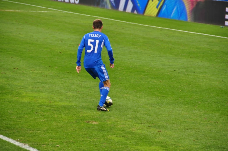 a man on the field is kicking a soccer ball