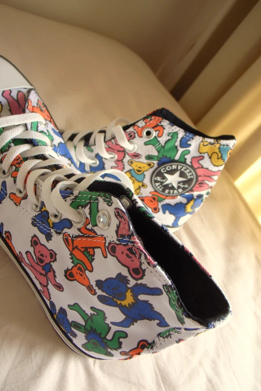 a pair of sneakers with cartoon prints on them