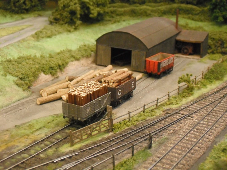 a model railway with two trains parked near buildings