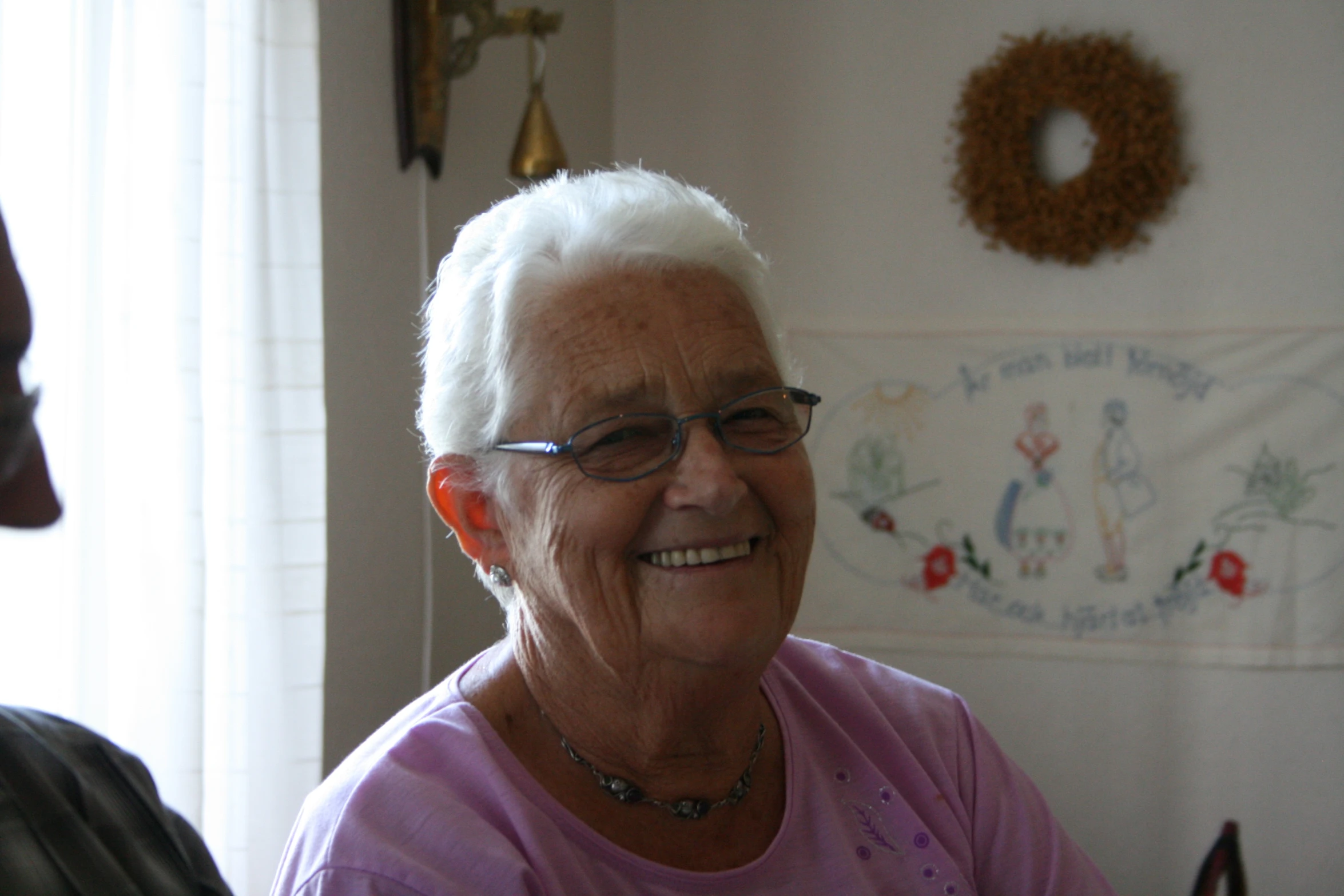 a woman with eye glasses is smiling at the camera