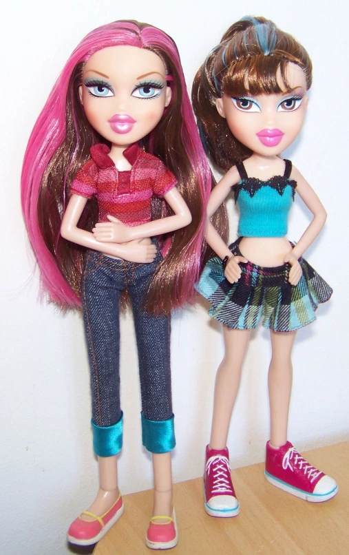 two doll in different clothes standing near each other