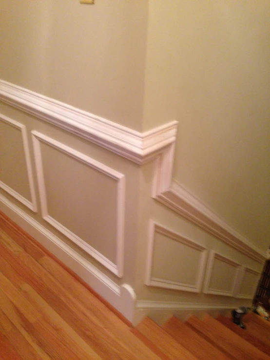 a corner of a room with wooden flooring