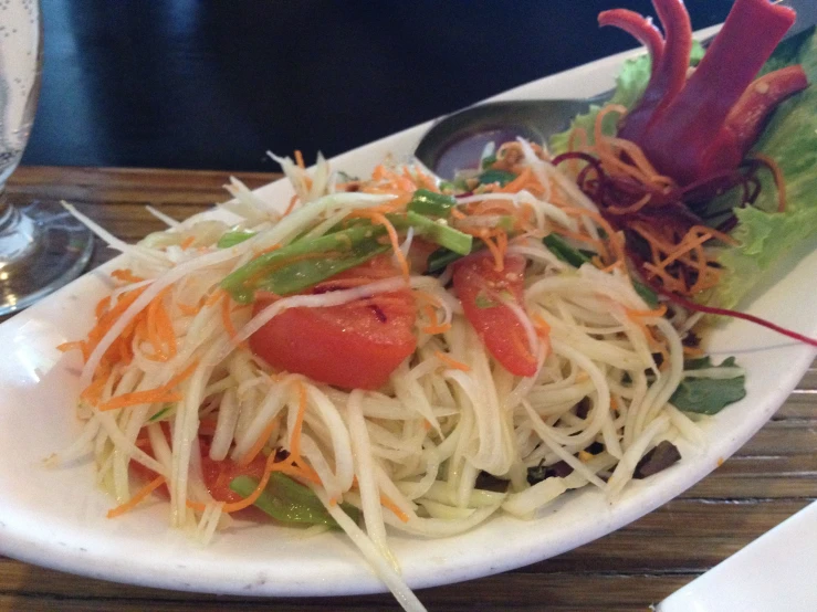 a plate with some vegetables and a silver spoon