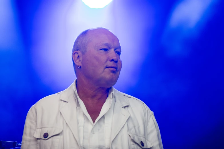 an image of a man with microphone in front of lights