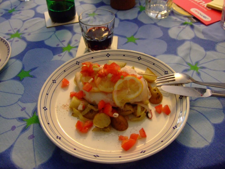 a plate topped with food on top of a table