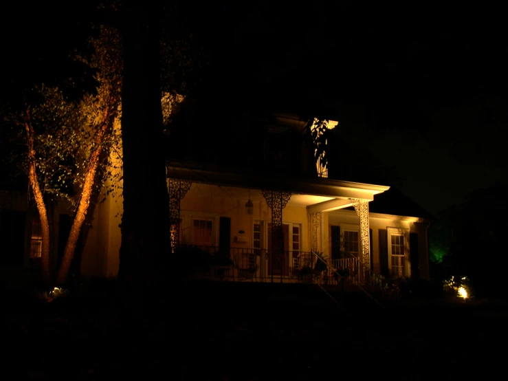 a house lit up with lights at night